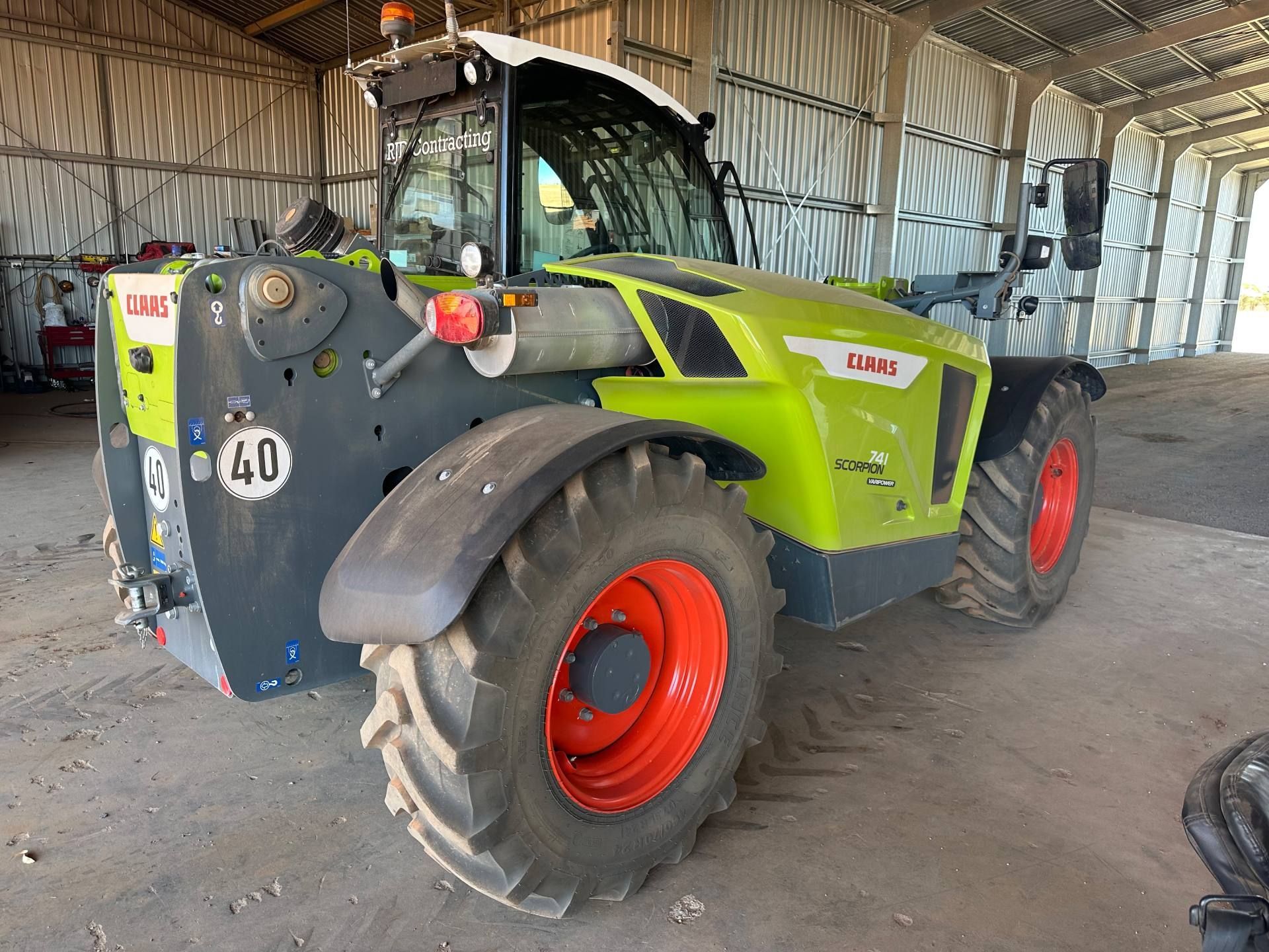 A tractor with the number 40 on the back is parked in a warehouse.