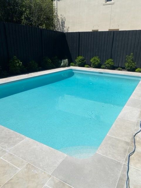 Backyard Swimming Pool With Clear Blue Water — Mad Pool Interiors and Renovations in Baringa, QLD