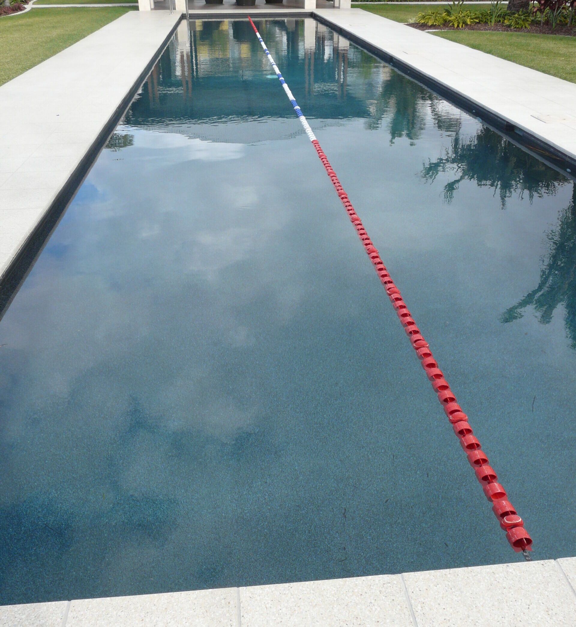 Long, Rectangular Swimming Pool With Lane Markers — Mad Pool Interiors and Renovations in Baringa, QLD