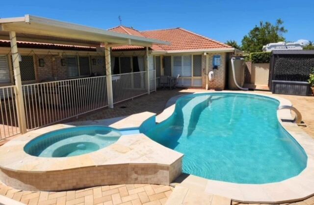 Backyard Swimming Pool With a Built-in Spa — Mad Pool Interiors and Renovations in Baringa, QLD