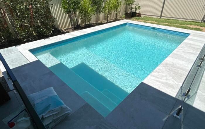 Backyard Swimming Pool with Clear Blue Water — Mad Pool Interiors and Renovations in Baringa, QLD