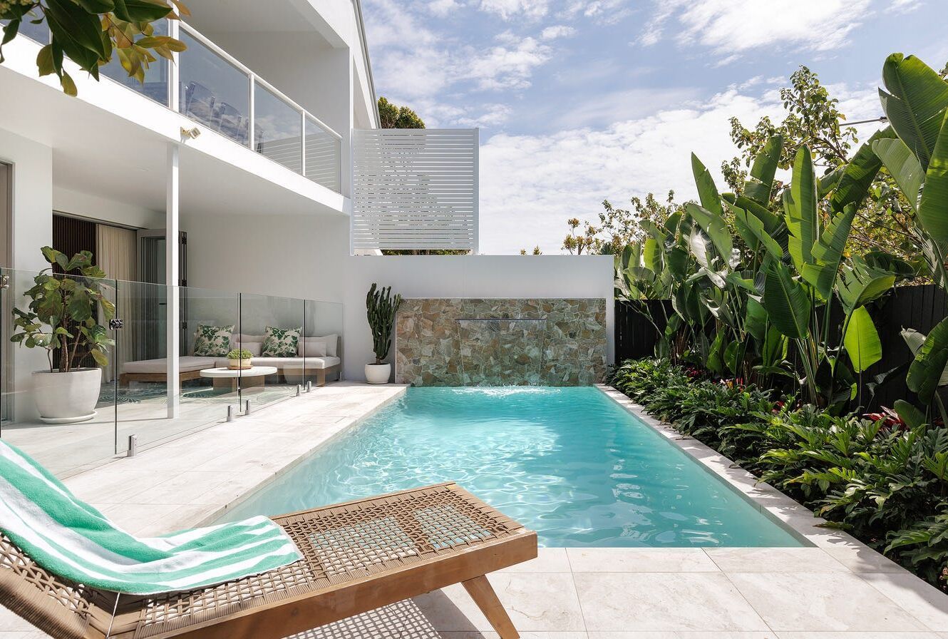 Backyard With Pool Outside of a White House — Mad Pool Interiors and Renovations in Baringa, QLD