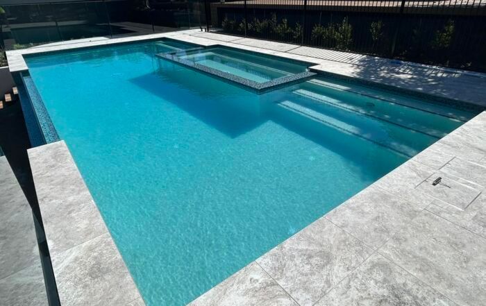 Modern Outdoor Swimming Pool with Turquoise Water — Mad Pool Interiors and Renovations in Baringa, QLD