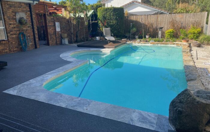 Backyard Swimming Pool with Clear Blue Water — Mad Pool Interiors and Renovations in Baringa, QLD