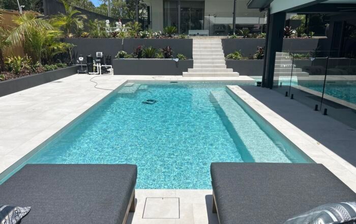 Modern Backyard Pool with Lounge Chairs — Mad Pool Interiors and Renovations in Baringa, QLD