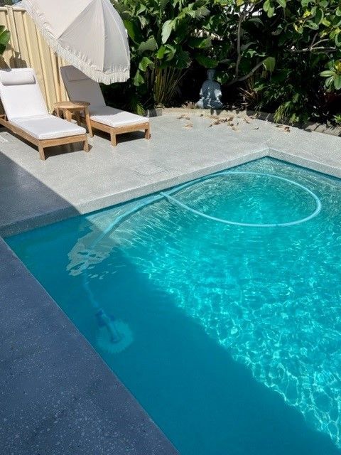 Sunny Poolside With Two Lounge Chairs — Mad Pool Interiors and Renovations in Baringa, QLD