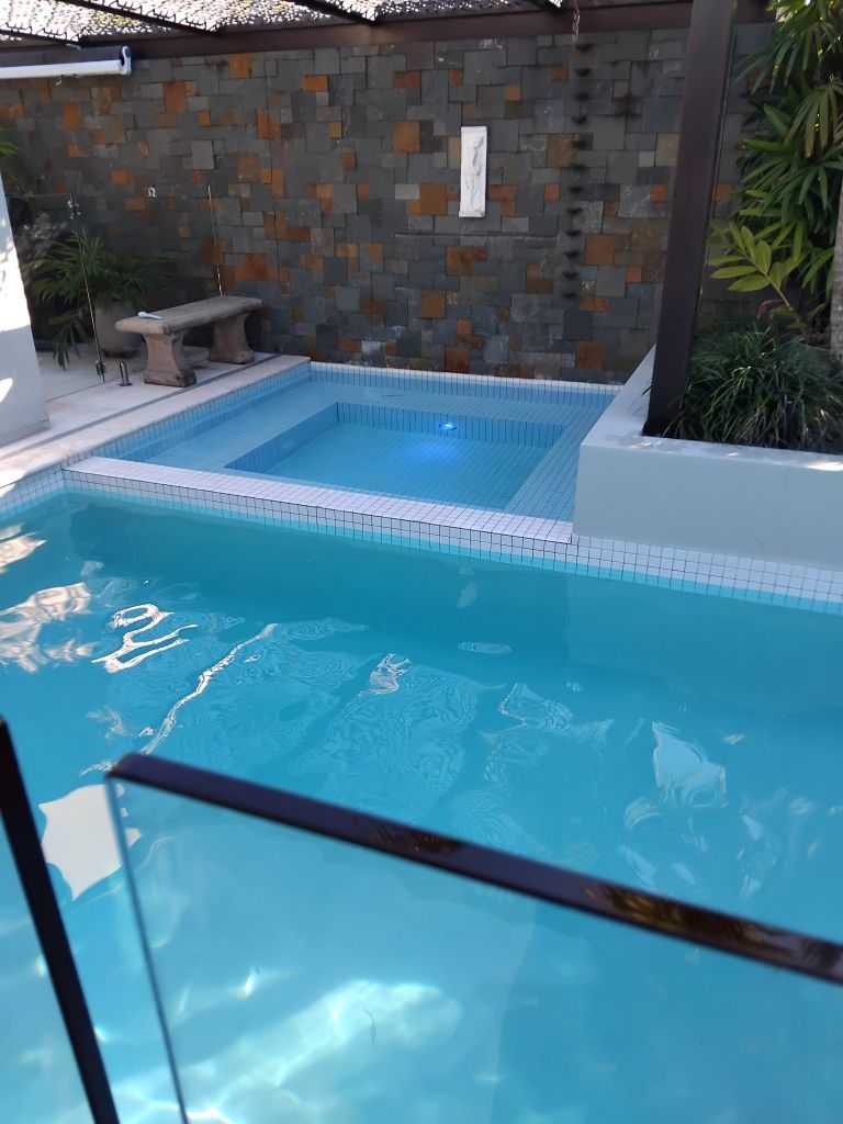 Swimming Pool With a Small Square Spa — Mad Pool Interiors and Renovations in Baringa, QLD