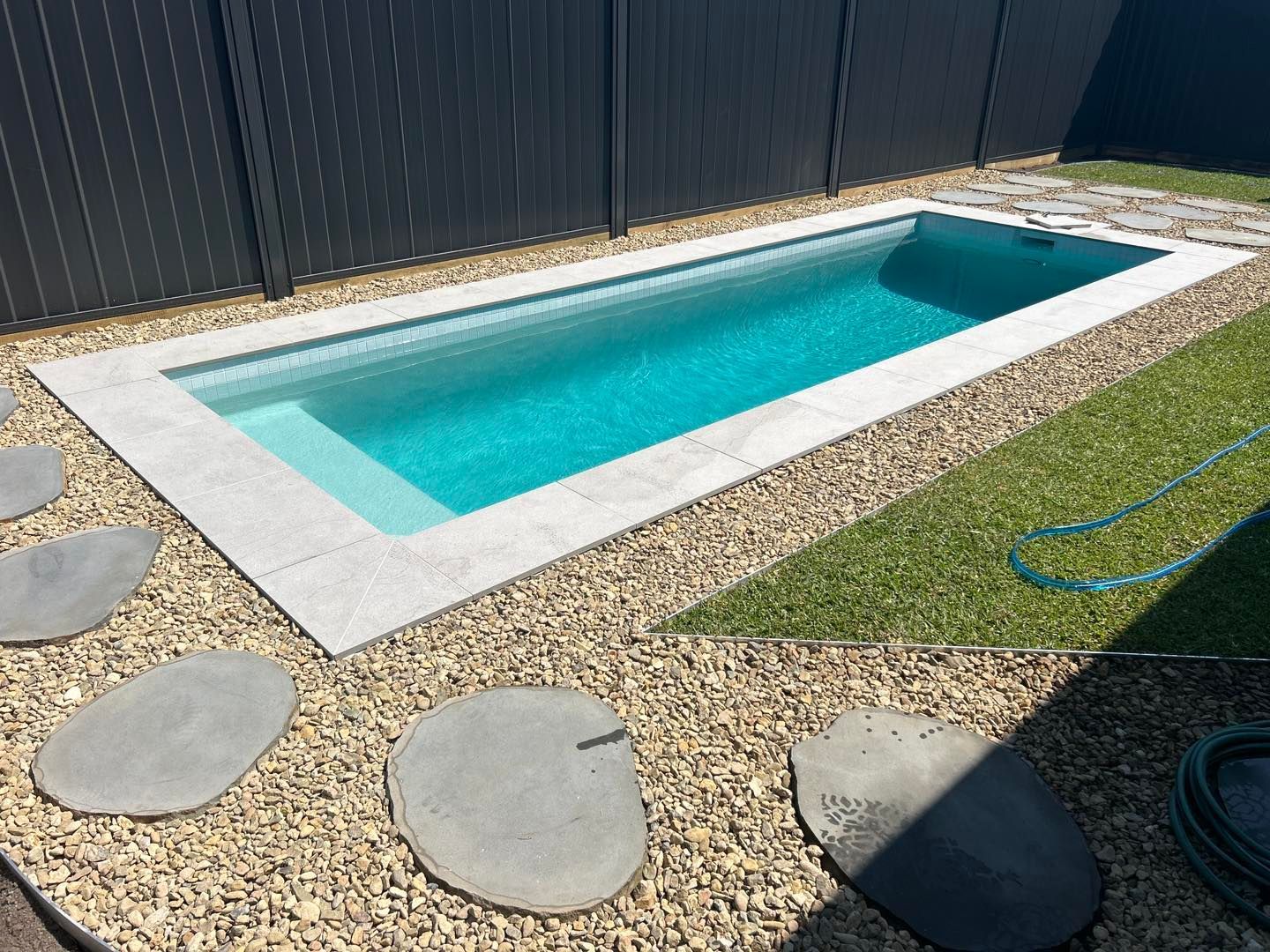 Rectangular Pool With Water, Surrounded by Light-colored Paving — Mad Pool Interiors and Renovations in Baringa, QLD
