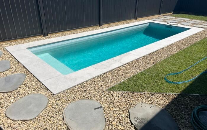 Rectangular Backyard Plunge Pool with White Coping — Mad Pool Interiors and Renovations in Baringa, QLD