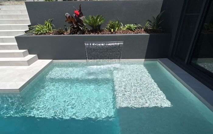 Modern Backyard Pool with Waterfall Spillway — Mad Pool Interiors and Renovations in Baringa, QLD