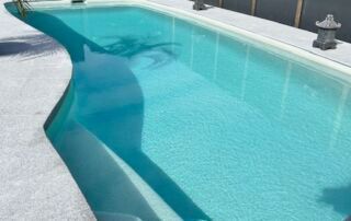 Turquoise Swimming Pool with A Curved White Deck — Mad Pool Interiors and Renovations in Baringa, QLD