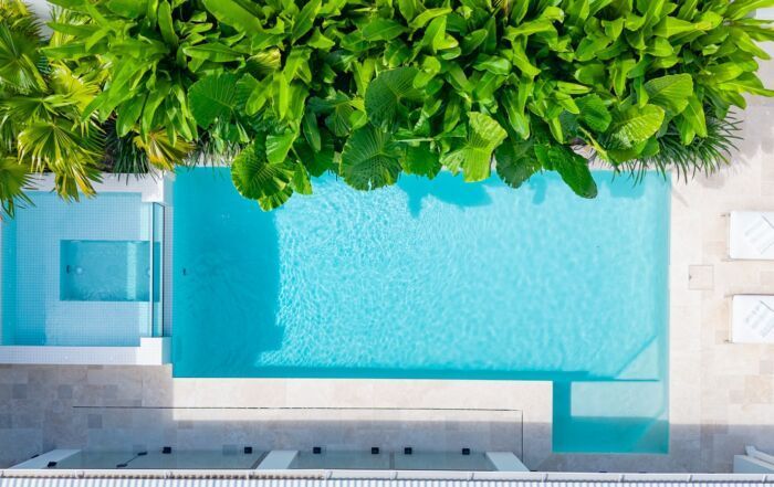 Aerial View of A Turquoise Swimming Pool Bordered — Mad Pool Interiors and Renovations in Baringa, QLD