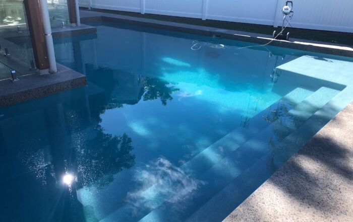 Blue Swimming Pool with Sunlight Reflections — Mad Pool Interiors and Renovations in Baringa, QLD
