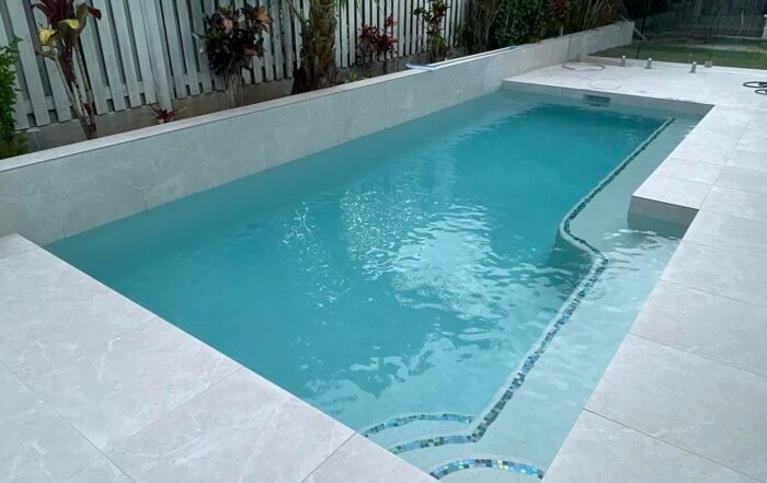 Small Turquoise Backyard Swimming Pool — Mad Pool Interiors and Renovations in Baringa, QLD