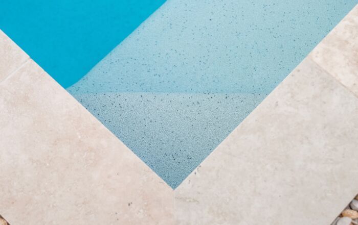 Geometric Pool Edge with Blue and White Triangular Tiles — Mad Pool Interiors and Renovations in Baringa, QLD