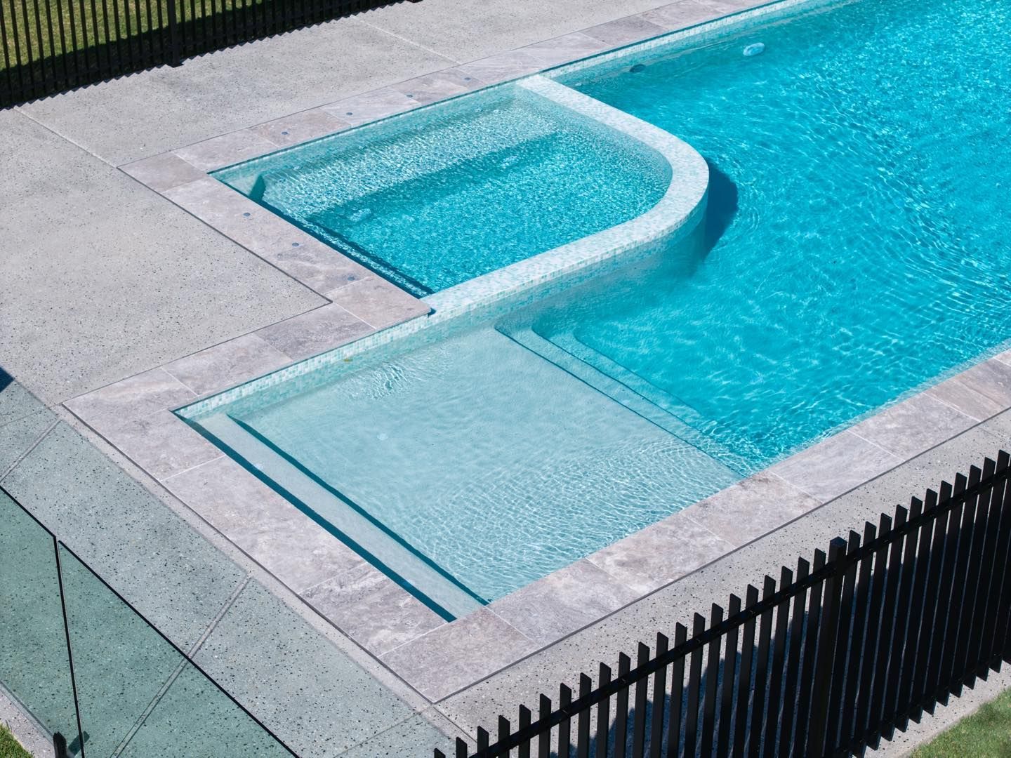 Swimming Pool With a Curved Shallow Entry Ramp — Mad Pool Interiors and Renovations in Baringa, QLD