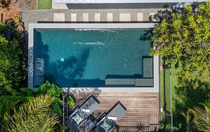 Aerial View of A Backyard Pool Beside a Wooden Deck — Mad Pool Interiors and Renovations in Baringa, QLD