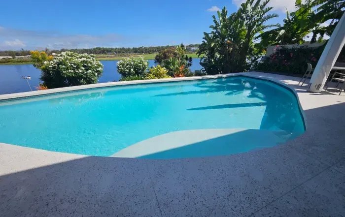 Curved Turquoise Swimming Pool — Mad Pool Interiors and Renovations in Baringa, QLD