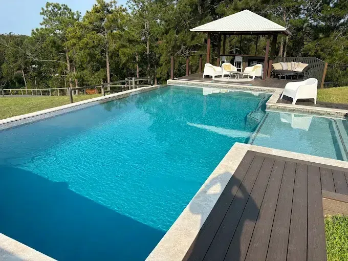 Outdoor Swimming Pool With Lounge Chairs and a Shaded Cabana — Mad Pool Interiors and Renovations in Baringa, QLD