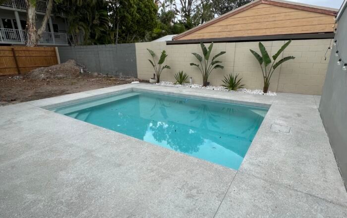 Small Backyard with A Turquoise Swimming Pool — Mad Pool Interiors and Renovations in Baringa, QLD