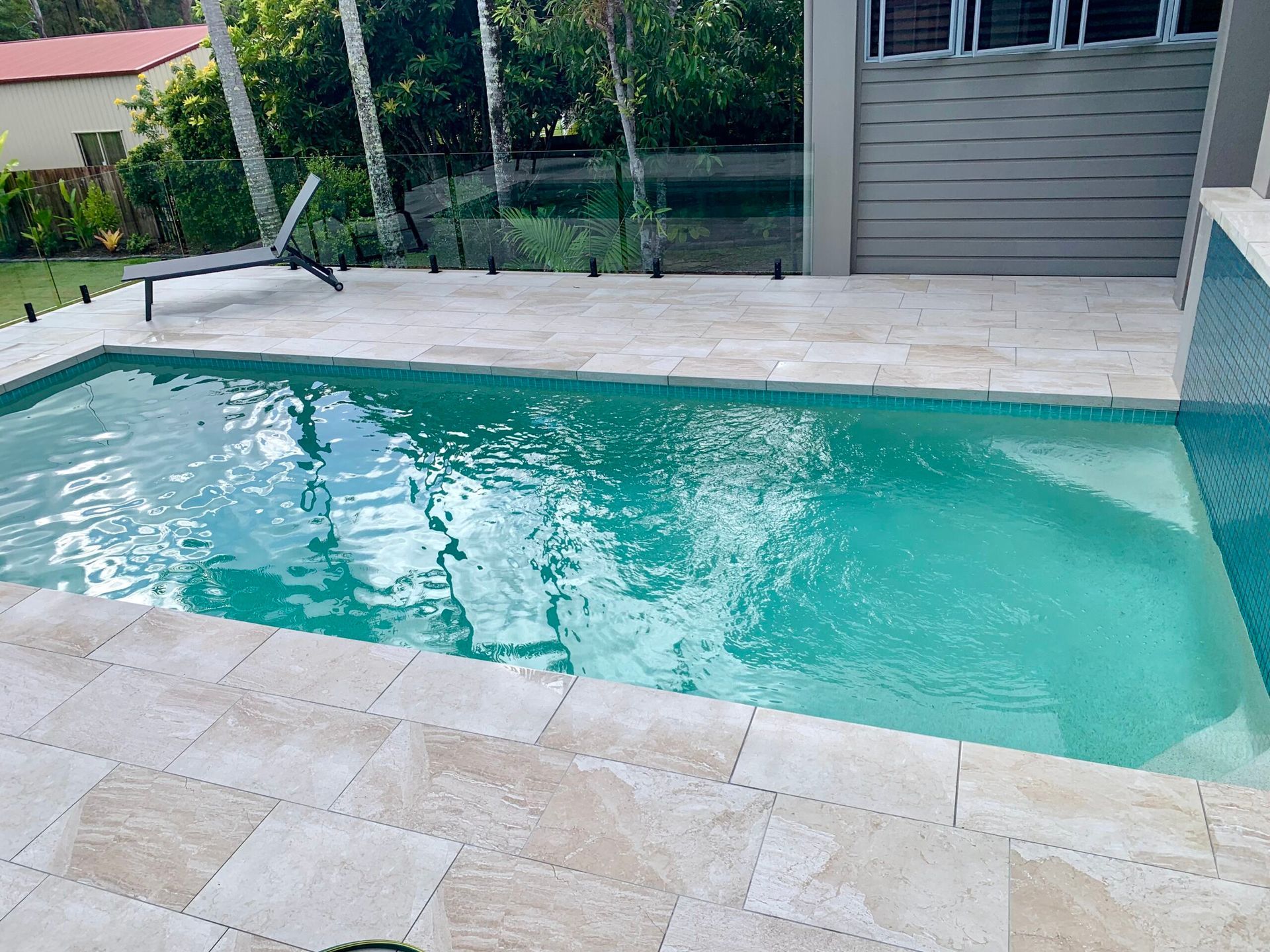 Pool With Light-colored Tile Surround and Turquoise Water, Steps — Mad Pool Interiors and Renovations in Baringa, QLD