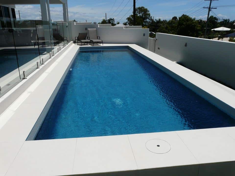 Rooftop Swimming Pool With Blue Water — Mad Pool Interiors and Renovations in Baringa, QLD
