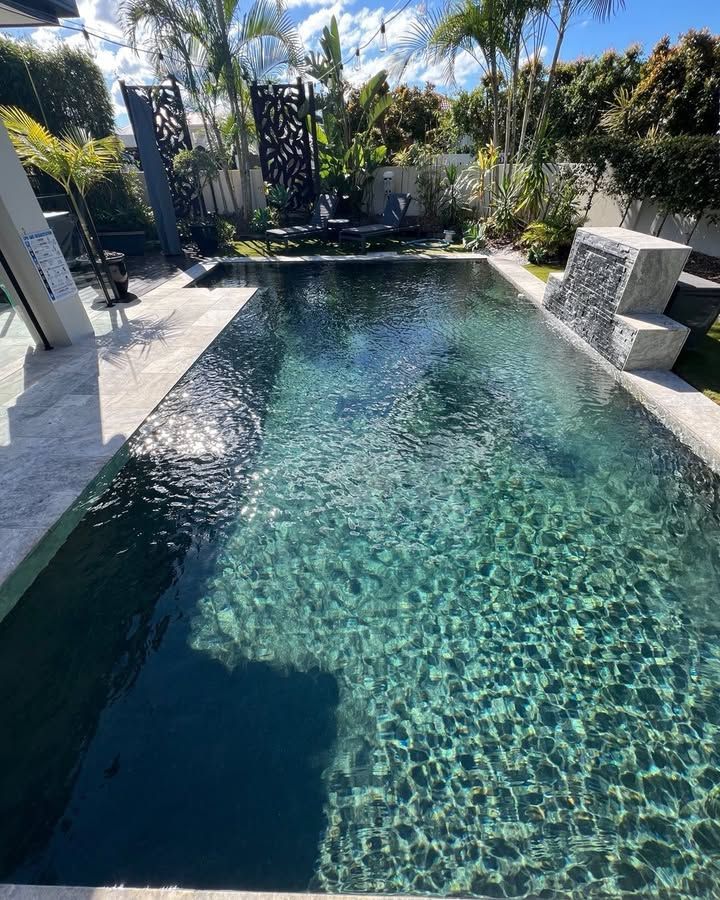 Rectangular Pool With Dark Water; Waterfall Feature — Mad Pool Interiors and Renovations in Baringa, QLD