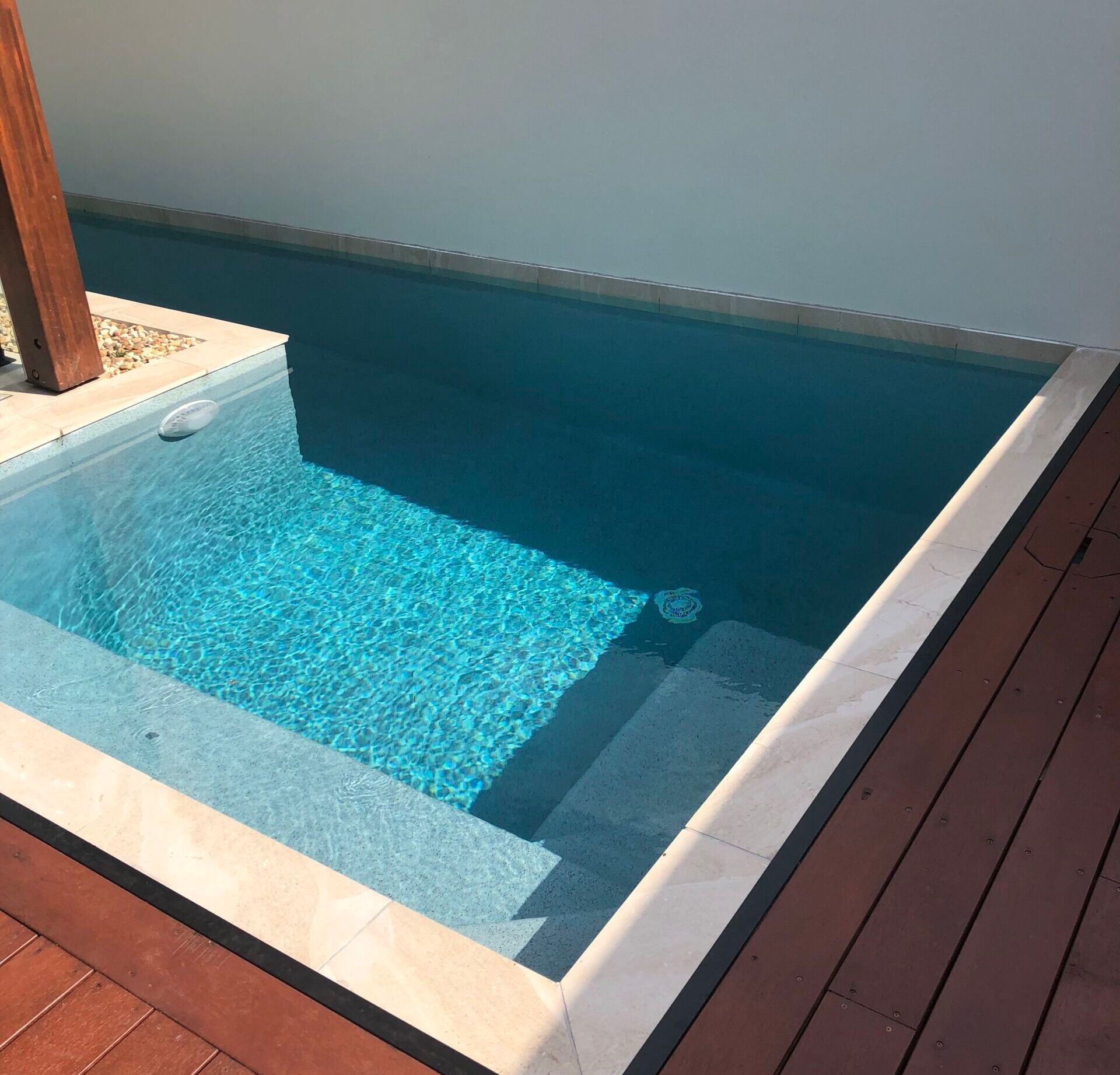 Small Rectangular Pool With Steps, Surrounded by Wood Decking — Mad Pool Interiors and Renovations in Baringa, QLD