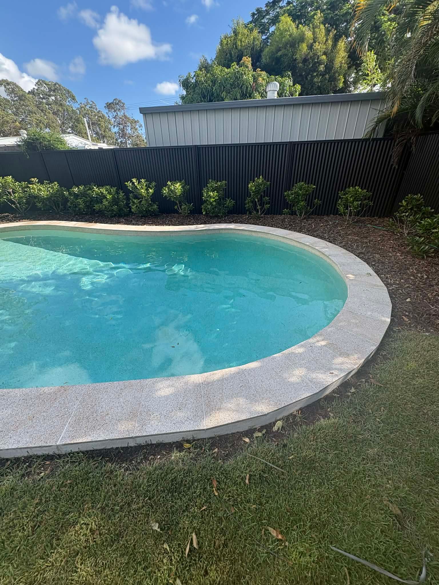 Pool With Light Blue Water and Stone Edge — Mad Pool Interiors and Renovations in Baringa, QLD
