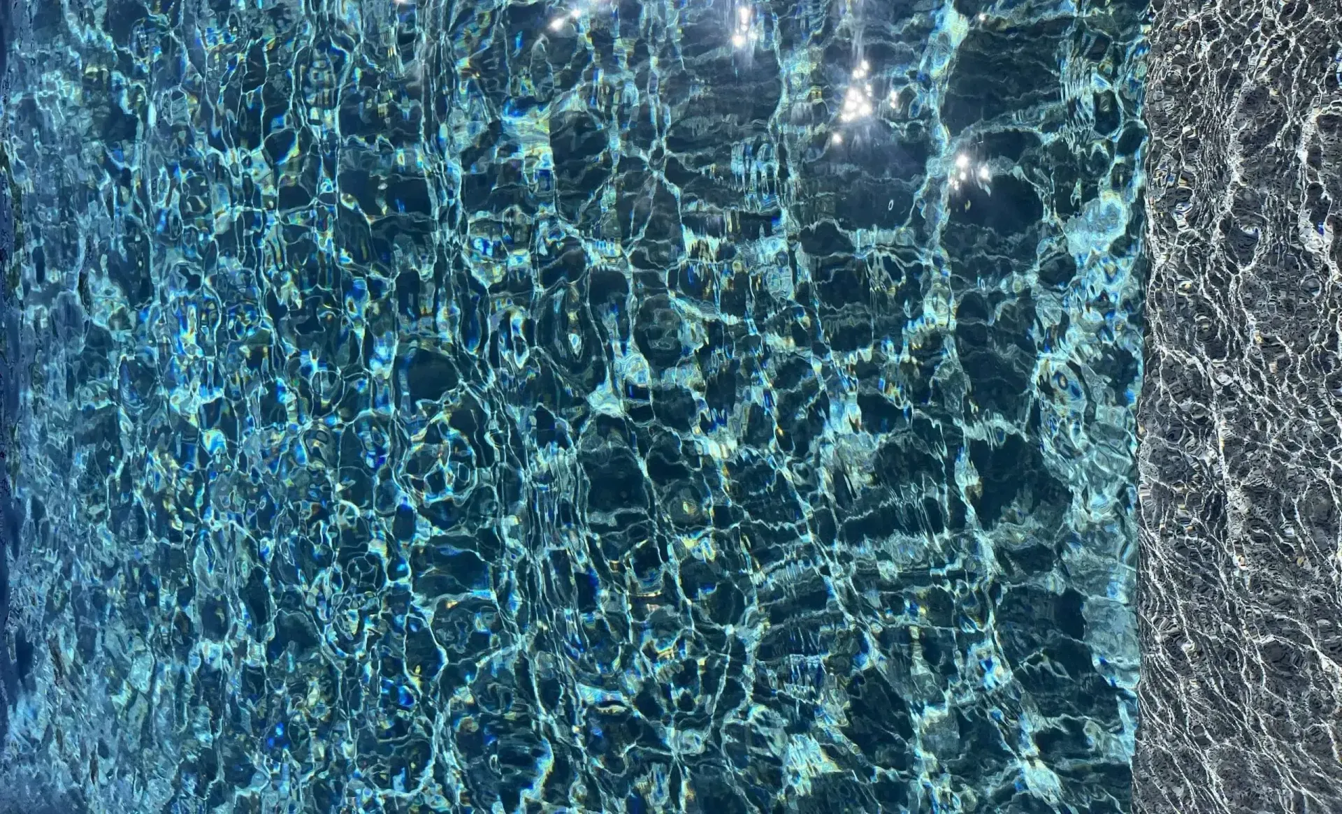 Clear Blue Water With Sunlight Reflections — Mad Pool Interiors and Renovations in Baringa, QLD