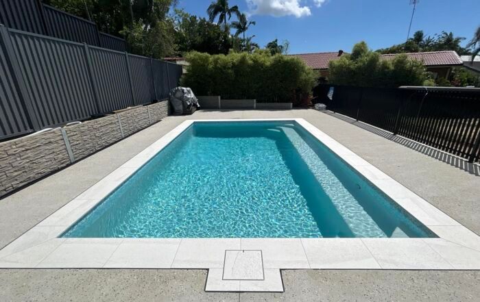 Rectangular Backyard Swimming Pool with Turquoise Water — Mad Pool Interiors and Renovations in Baringa, QLD