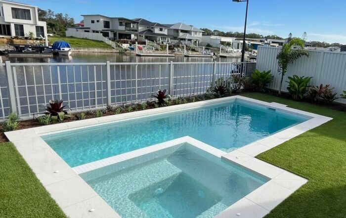 Backyard Pool with A Shallow Splash Area — Mad Pool Interiors and Renovations in Baringa, QLD