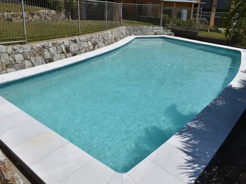 Outdoor Swimming Pool With Turquoise Water and White Deck — Mad Pool Interiors and Renovations in Baringa, QLD