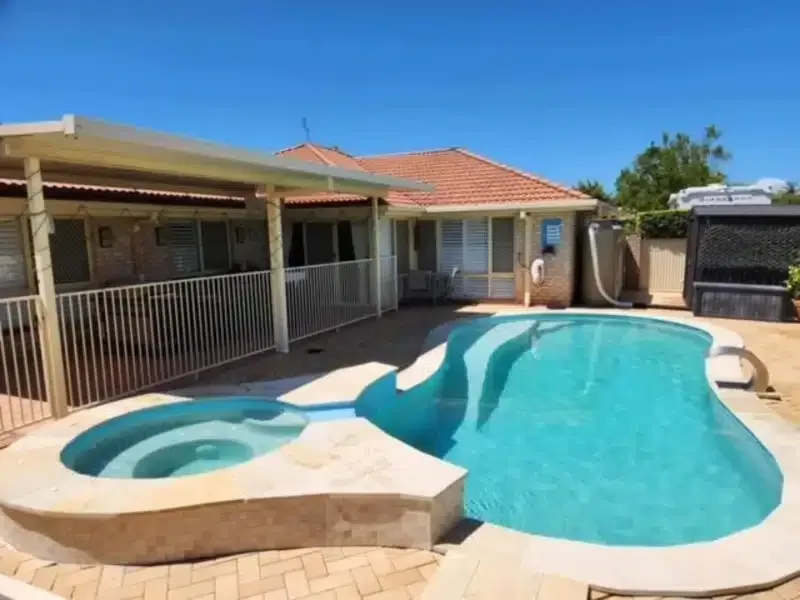 Backyard With Curved Swimming Pool and SPA — Mad Pool Interiors and Renovations in Baringa, QLD