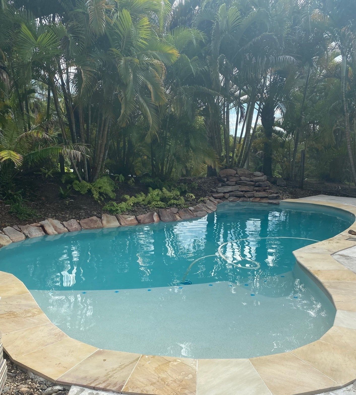 A Swimming Pool With Turquoise Water — Mad Pool Interiors and Renovations in Baringa, QLD