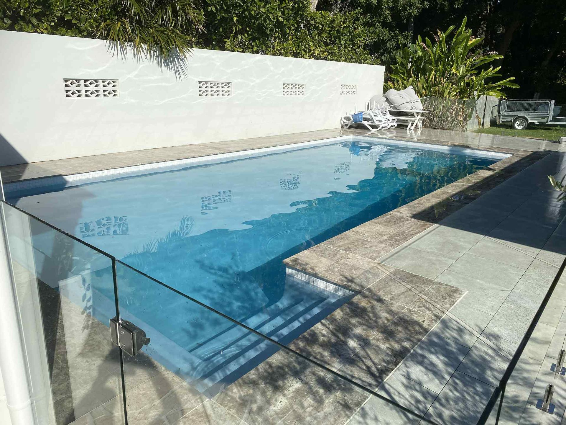 Backyard Swimming Pool With Clear Blue Water — Mad Pool Interiors and Renovations in Baringa, QLD