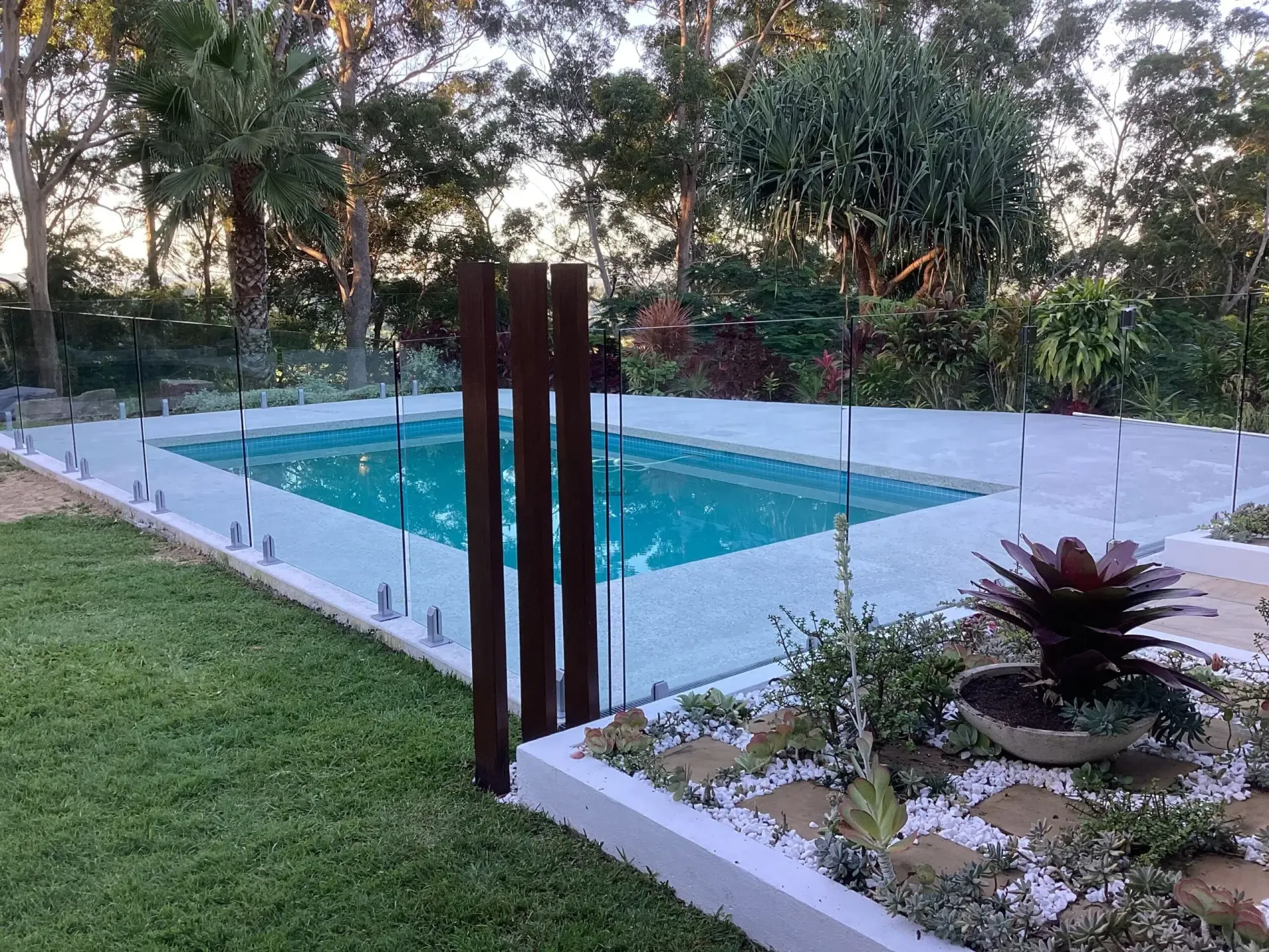 Backyard Pool With Glass Fence — Mad Pool Interiors and Renovations in Baringa, QLD