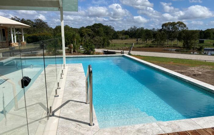 Outdoor Swimming Pool with Bright Blue Water — Mad Pool Interiors and Renovations in Baringa, QLD