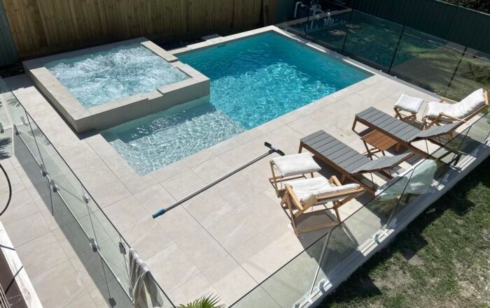 Modern Backyard Pool with Hot Tub and Lounge Chairs — Mad Pool Interiors and Renovations in Baringa, QLD