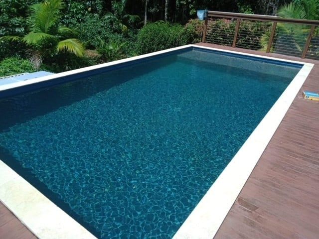 Rectangular Swimming Pool With Dark Blue Water — Mad Pool Interiors and Renovations in Baringa, QLD