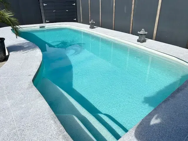 Small Turquoise Backyard Swimming Pool With White Coping — Mad Pool Interiors and Renovations in Baringa, QLD