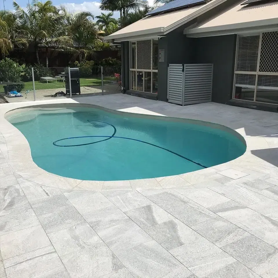 Backyard Swimming Pool Beside a Modern House — Mad Pool Interiors and Renovations in Baringa, QLD