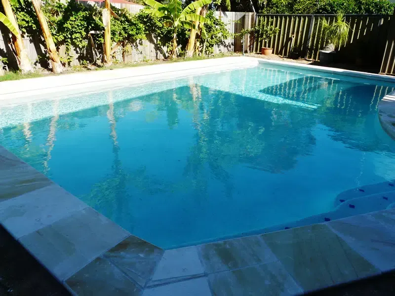 Sunny Backyard Swimming Pool — Mad Pool Interiors and Renovations in Baringa, QLD