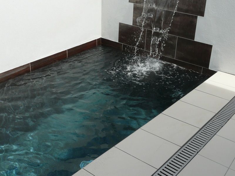 Small Indoor Pool With Dark Tiles Interior Filled With Water — Mad Pool Interiors and Renovations in Baringa, QLD