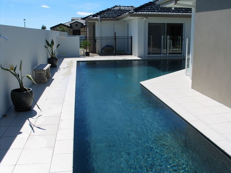 A Rectangular Pool With Dark Blue Water — Mad Pool Interiors and Renovations in Baringa, QLD