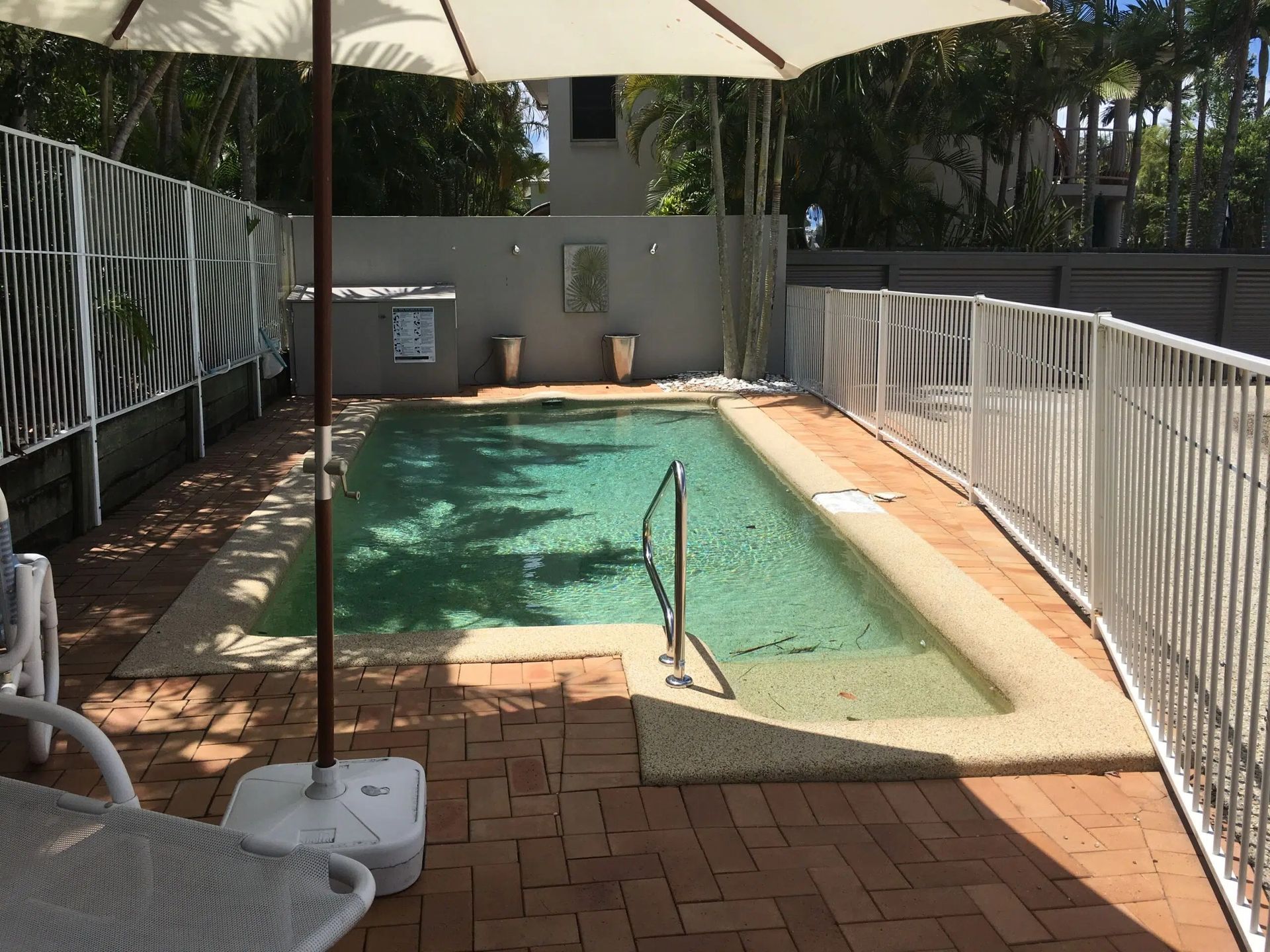 Small Outdoor Pool With White Railing — Mad Pool Interiors and Renovations in Baringa, QLD