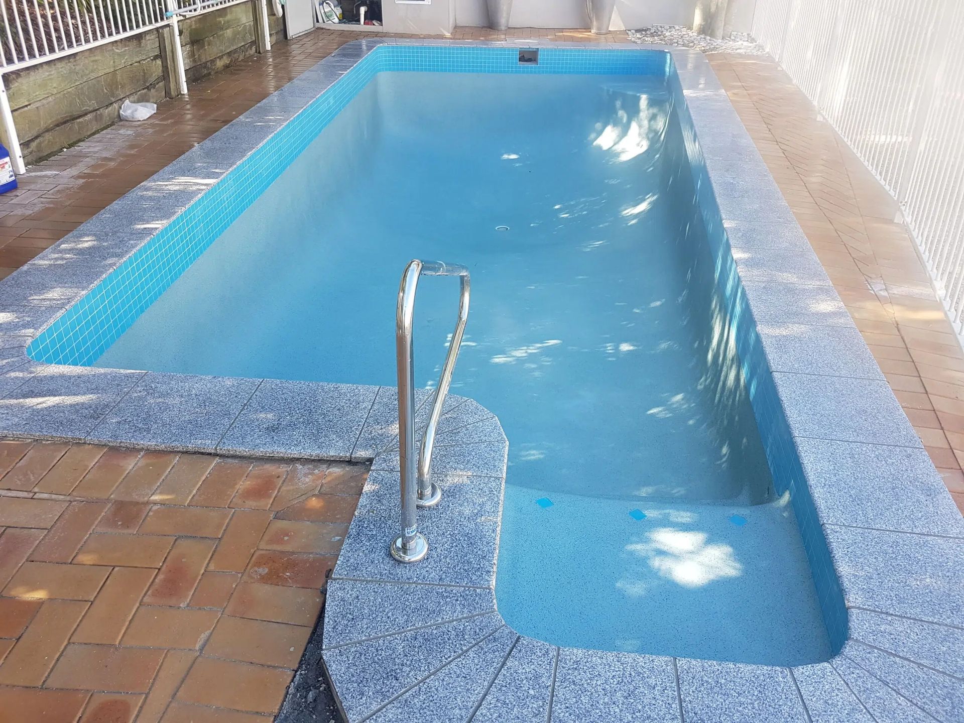 Indoor Swimming Pool With a Blue Tiled Lane — Mad Pool Interiors and Renovations in Baringa, QLD