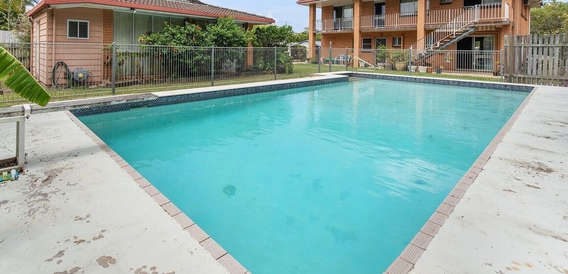 Outdoor Swimming Pool With Turquoise Water — Mad Pool Interiors and Renovations in Baringa, QLD
