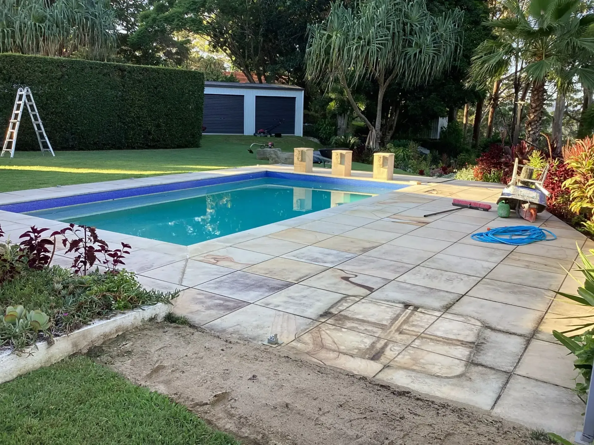 Backyard Pool With Stone Patio — Mad Pool Interiors and Renovations in Baringa, QLD