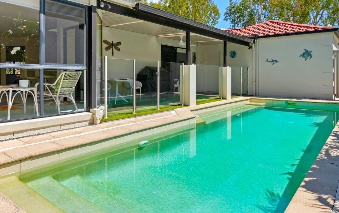 Modern Backyard With a Turquoise Swimming Pool — Mad Pool Interiors and Renovations in Baringa, QLDv